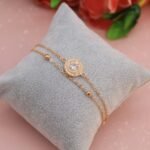 a diamond bracelet on a pillow with a rose in the background